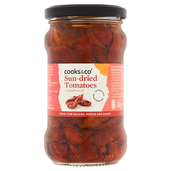 Line Cook Wearing A Striped Apron And A Black Bandana Cutting A Vegetable Next To Two Other Cooks